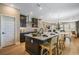 Open-concept kitchen with island seating flows seamlessly into the dining and living areas for easy entertaining at 15201 Summer Harvest St, Winter Garden, FL 34787