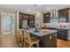 Modern kitchen boasts dark cabinets, a spacious island with seating, and stainless steel appliances at 15201 Summer Harvest St, Winter Garden, FL 34787