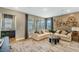 Comfortable living room features neutral tones, a large sectional sofa, and unique wall decor at 15201 Summer Harvest St, Winter Garden, FL 34787