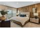 Warm bedroom with wood-paneled wall, soft lighting, and a plush bed create a relaxing atmosphere at 15201 Summer Harvest St, Winter Garden, FL 34787