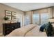 Serene bedroom with a walkout balcony, neutral tones, and inviting decor for a restful retreat at 15201 Summer Harvest St, Winter Garden, FL 34787