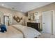 Bright main bedroom features a dark dresser, ensuite bathroom, and plenty of storage space at 15201 Summer Harvest St, Winter Garden, FL 34787