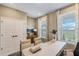 Bright office space with two windows, neutral walls and stylish curtains, and a decorative storage cabinet at 15201 Summer Harvest St, Winter Garden, FL 34787