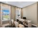 Bright office space with two windows, neutral walls, stylish curtains and built-in bookshelves in the desk at 15201 Summer Harvest St, Winter Garden, FL 34787