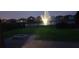 Nighttime view of a fenced in backyard with a water feature at 16124 Azure Key St, Winter Garden, FL 34787
