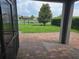 View from the patio to the backyard featuring a pond and mature tree at 16124 Azure Key St, Winter Garden, FL 34787