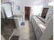 Bright bathroom with double vanity, granite countertop, separate shower, bathtub, and walk-in closet at 16124 Azure Key St, Winter Garden, FL 34787