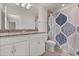 Bright bathroom with dual sinks, granite counters, and shower tub combo at 16124 Azure Key St, Winter Garden, FL 34787
