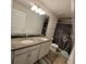 Elegant bathroom featuring double sink granite vanity and shower-tub combination at 16124 Azure Key St, Winter Garden, FL 34787