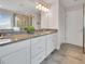Bright bathroom features granite countertop vanity, large mirror, and walk-in shower at 16124 Azure Key St, Winter Garden, FL 34787