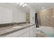 Bathroom featuring dual sinks with granite countertops and a shower-tub combo at 16124 Azure Key St, Winter Garden, FL 34787