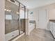 Modern bathroom with walk-in shower, soaking tub, and double vanity at 16124 Azure Key St, Winter Garden, FL 34787