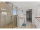 Bright bathroom showcasing a glass shower, soaking tub, and doorway to the walk-in closet at 16124 Azure Key St, Winter Garden, FL 34787