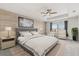 Beautiful primary bedroom boasts a wood accent wall, ample natural light, and modern furnishings at 16124 Azure Key St, Winter Garden, FL 34787