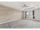 Spacious bedroom with accent wall, tray ceiling, and plush carpet at 16124 Azure Key St, Winter Garden, FL 34787