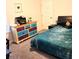 This is a cozy bedroom with colorful furniture, a black headboard, and an adjacent door at 16124 Azure Key St, Winter Garden, FL 34787
