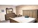 Comfortable bedroom featuring a bed with a wooden headboard, dresser with mirror, and a neutral color palette at 16124 Azure Key St, Winter Garden, FL 34787