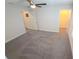 Spacious room with plush carpeting, a lighted ceiling fan, and a closet with natural light at 16124 Azure Key St, Winter Garden, FL 34787