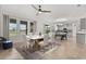 Bright dining room with large windows, modern table, and views of the backyard at 16124 Azure Key St, Winter Garden, FL 34787