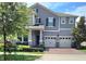Charming two-story home with a three car garage and manicured landscaping at 16124 Azure Key St, Winter Garden, FL 34787