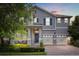 Beautiful two-story home featuring a three-car garage, covered porch and a landscaped yard at 16124 Azure Key St, Winter Garden, FL 34787