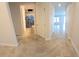 Hallway with neutral paint colors and tile floors leads to a bathroom and additional living space at 16124 Azure Key St, Winter Garden, FL 34787