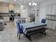 Open kitchen featuring an island with seating and adjacent dining area with a dark wood bench at 16124 Azure Key St, Winter Garden, FL 34787