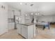 Open-concept kitchen features a central island, stainless steel appliances, and modern backsplash at 16124 Azure Key St, Winter Garden, FL 34787