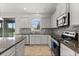 Bright kitchen features stainless steel appliances, mosaic backsplash, and ample counter space at 16124 Azure Key St, Winter Garden, FL 34787