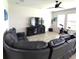 Comfortable living room featuring a large sectional sofa and a ceiling fan at 16124 Azure Key St, Winter Garden, FL 34787