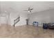 Spacious living room featuring neutral paint, tile flooring, and staircase at 16124 Azure Key St, Winter Garden, FL 34787