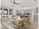 Open-concept living room boasts lots of natural light and transitions into a bright and modern kitchen at 16124 Azure Key St, Winter Garden, FL 34787