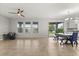 Open living space with tile floors, fan, lots of natural light, table and backyard access at 16124 Azure Key St, Winter Garden, FL 34787