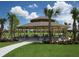A community pavilion with picnic tables, surrounded by lush greenery and trees at 16124 Azure Key St, Winter Garden, FL 34787