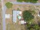 Overhead view of property with a pool, storage, and driveway on a sprawling green lawn at 18906 Merrich Rd, Orlando, FL 32820