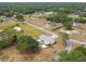 Expansive aerial view of a home with a pool, spacious yard, and surrounding lush greenery at 18906 Merrich Rd, Orlando, FL 32820