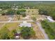 A birds-eye view showcases the property, home, pool, yard, and surrounding wooded area at 18906 Merrich Rd, Orlando, FL 32820