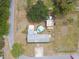 Aerial view of the property showcasing the home's layout, pool, outbuildings, and landscaping at 18906 Merrich Rd, Orlando, FL 32820