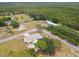 Aerial view of home with a pool, storage shed, carport and large tree at 18906 Merrich Rd, Orlando, FL 32820