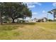 Large backyard featuring a trailer, storage shed, carport, above-ground pool, and covered porch at 18906 Merrich Rd, Orlando, FL 32820