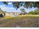 Expansive backyard featuring an above-ground pool, covered deck, and ample green space at 18906 Merrich Rd, Orlando, FL 32820