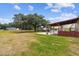 Expansive backyard featuring a covered pergola, inviting pool, and ample outdoor space at 18906 Merrich Rd, Orlando, FL 32820