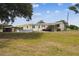 Spacious backyard with a pool, shed, and covered porch, ideal for outdoor living at 18906 Merrich Rd, Orlando, FL 32820