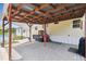Backyard patio with pergola, perfect for outdoor dining, with an outdoor grill at 18906 Merrich Rd, Orlando, FL 32820