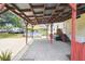Spacious backyard patio featuring a covered pergola and convenient access to the above-ground pool at 18906 Merrich Rd, Orlando, FL 32820