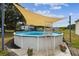 Enjoy the refreshing backyard above-ground pool with adjacent pergola, perfect for summer relaxation at 18906 Merrich Rd, Orlando, FL 32820