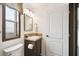 Compact bathroom featuring neutral tones, a framed mirror, and tiled countertops at 18906 Merrich Rd, Orlando, FL 32820