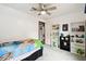 Bright bedroom featuring a ceiling fan, cozy carpeting, and built-in shelving for ample storage at 18906 Merrich Rd, Orlando, FL 32820