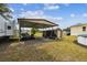 Carport next to shed provides ample outdoor storage space and parking on property at 18906 Merrich Rd, Orlando, FL 32820
