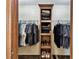 Walk-in closet with plenty of hanging space and storage shelving for shoes and folded clothes at 18906 Merrich Rd, Orlando, FL 32820